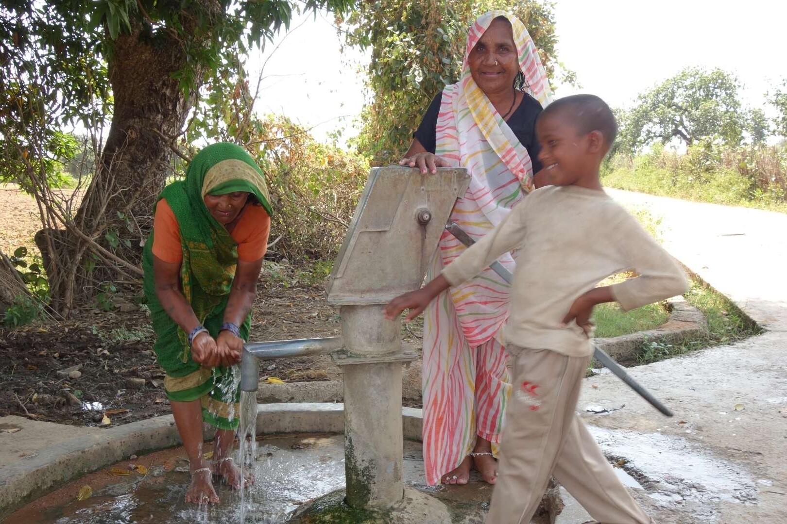 family at safe water pump