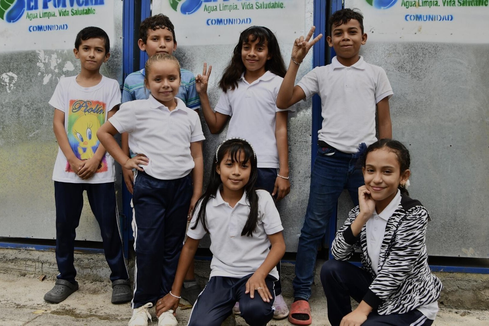 school children post by latrine block
