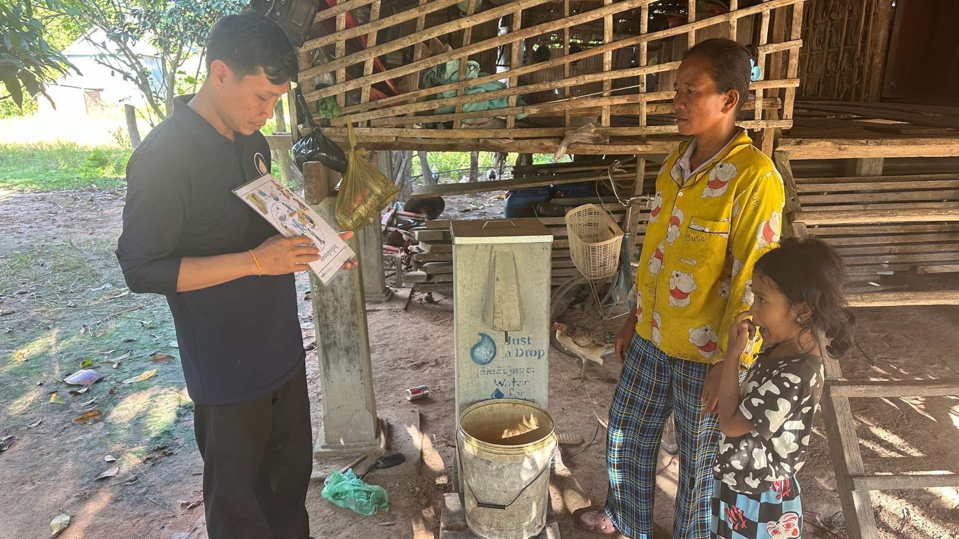 family receiving biosand filter training