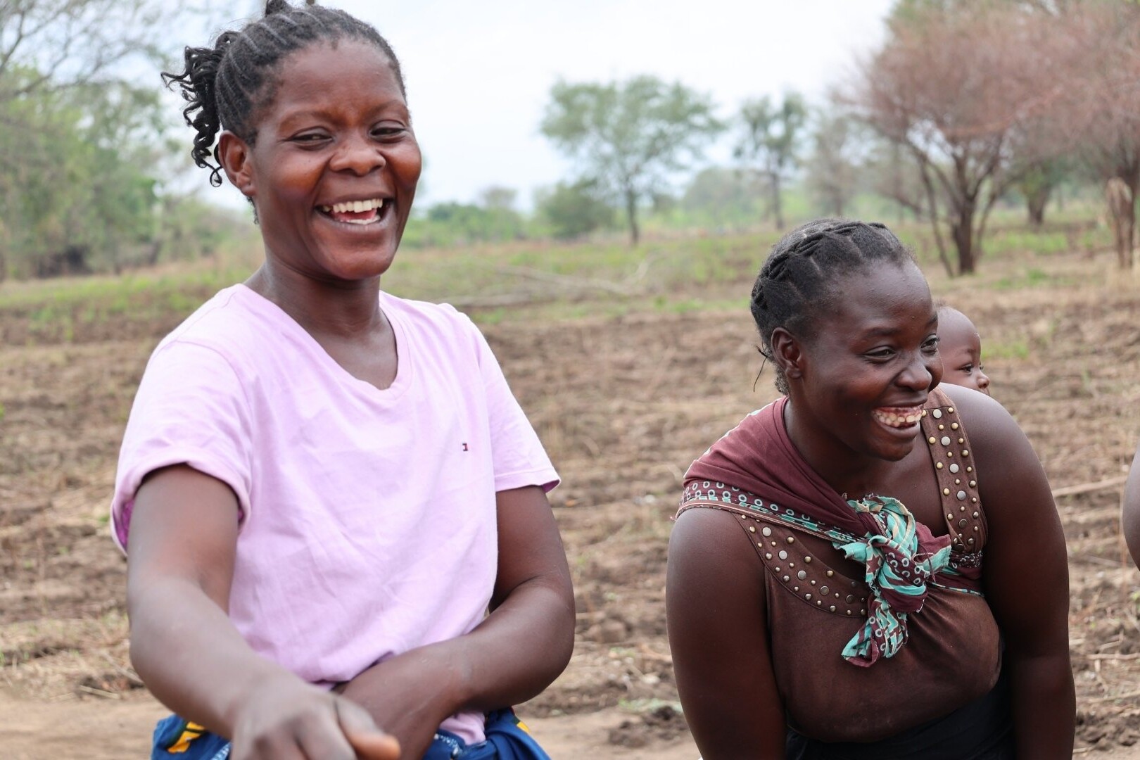 women in front of crop field