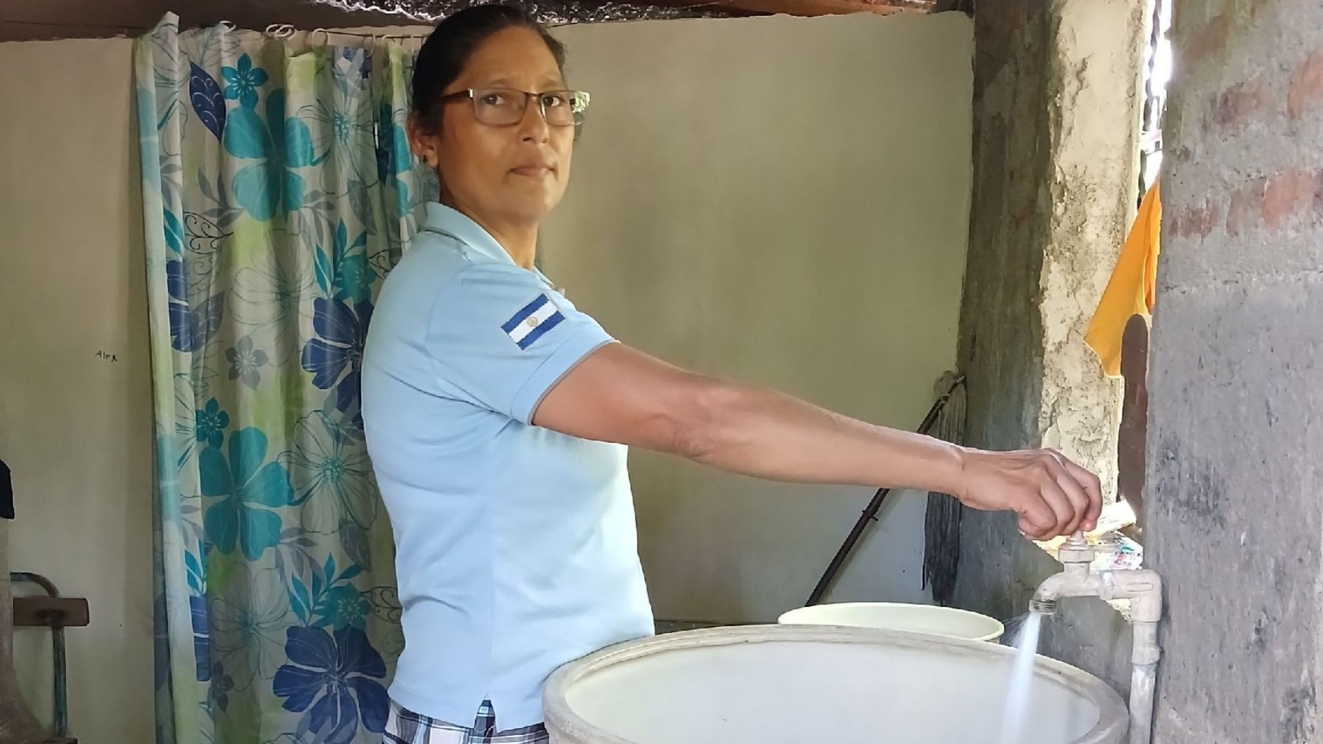 maria resa running tap in her home